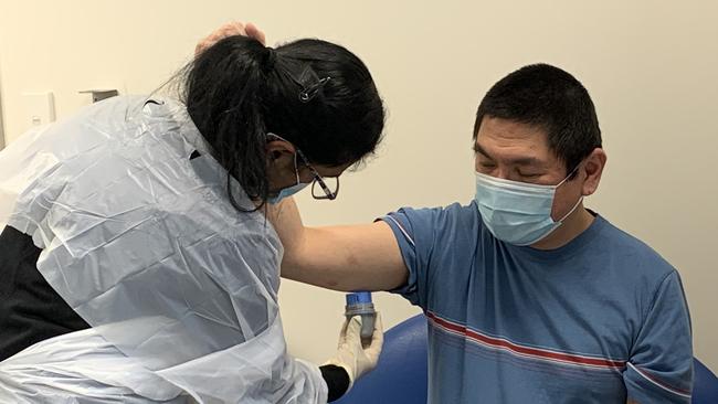 Ana Murugesan, the clinic’s Transitional Nurse Practitioner, inserts a continuous glucose monitoring (CGM) monitor into the arm of a patient referred to Mt Druitt Community Health Centre’s Diabetes Clinic. Picture: WSLHD