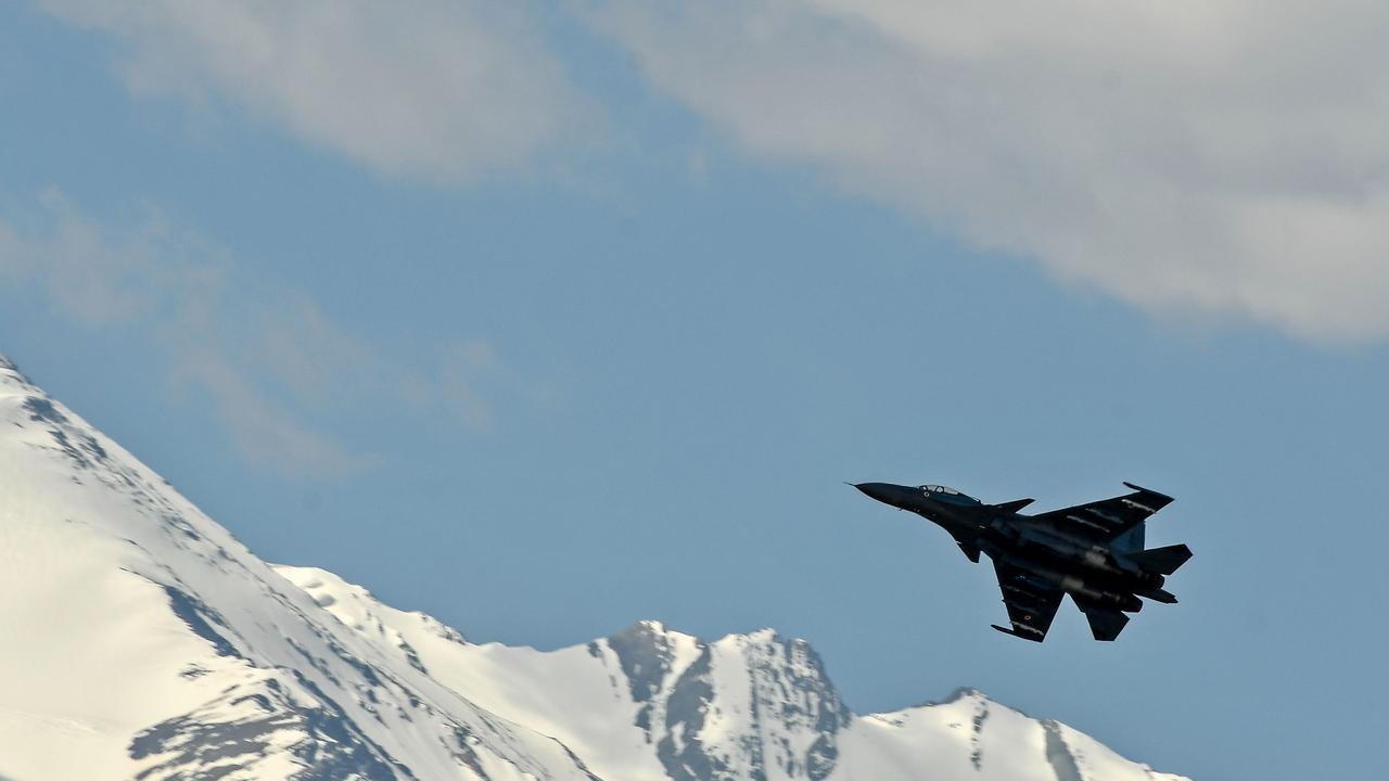 An Indian Air Force aircraft is seen against the backdrop of mountains surrounding Leh on June 27. Both India and China have been massing troops in the area. Picture: Tauseef Mustafa/AFP