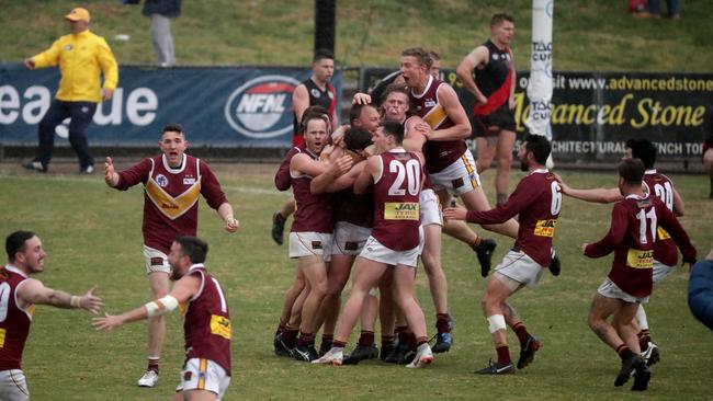 Lower Plenty teammates mob Ben Paterson after the final siren sounded.