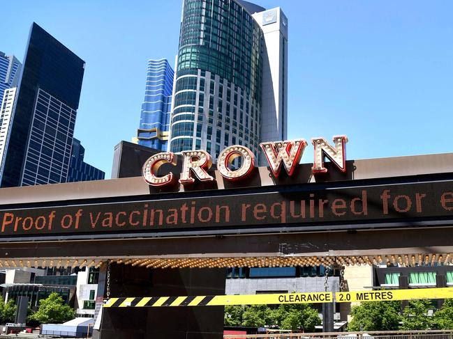 A Crown sign is displayed outside the Crown Casino in Melbourne on October 26, 2021. (Photo by William WEST / AFP)