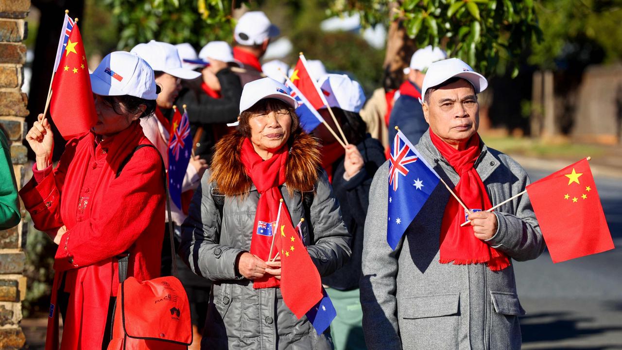 Supporters of Chinese Premier Li Qiang hold Australian and Chinese flags as they wait for his arrival at Magill Estate winery in Adelaide. Picture: NewsWire / Kelly Barnes