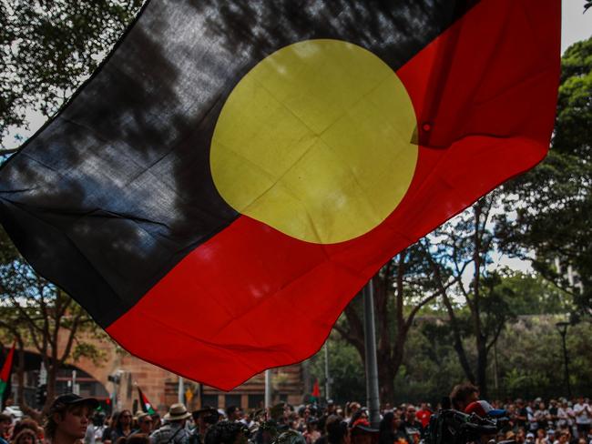 SYDNEY, AUSTRALIA - JANUARY 26: Demonstrators participate in a Invasion Day protest at Belmore Park on January 26, 2024 in Sydney, Australia. Australia Day, formerly known as Foundation Day, is the official national day of Australia and is celebrated annually on January 26 to commemorate the arrival of the First Fleet to Sydney in 1788. Many indigenous Australians refer to the day as 'Invasion Day' and there is a growing movement to change the date to one which can be celebrated by all Australians. In 2024, supermarket Chains Woolworths and Aldi announced that they would stop stocking themed merchandise for the day, drawing a political backlash from opposition leader Peter Dutton. (Photo by Roni Bintang/Getty Images)