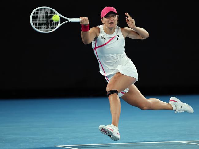 MELBOURNE, AUSTRALIA - JANUARY 18: Iga Swiatek of Poland plays a forehand in their round two singles match against Danielle Collins of the United States during the 2024 Australian Open at Melbourne Park on January 18, 2024 in Melbourne, Australia. (Photo by Cameron Spencer/Getty Images)