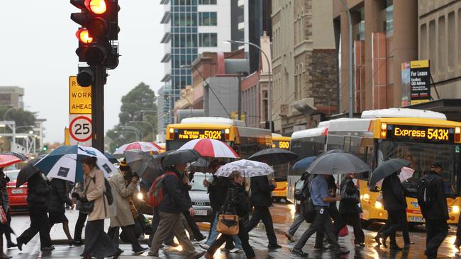 Afternoon commuters scramble to dodge the rain on Grenfell Street.