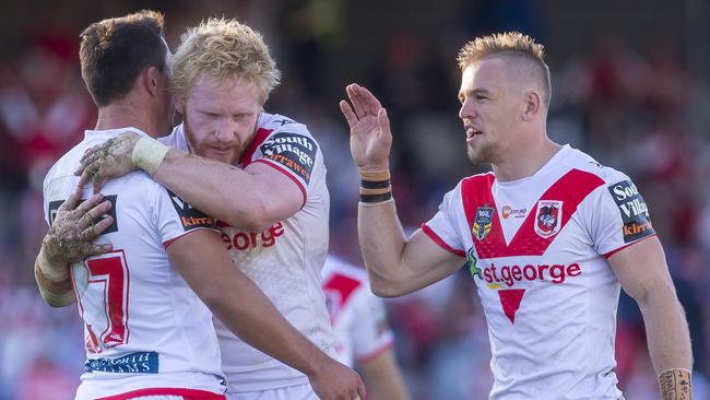 Reece Robson, James Graham and Matt Dufty celebrate the Dragons’ win over the Storm.