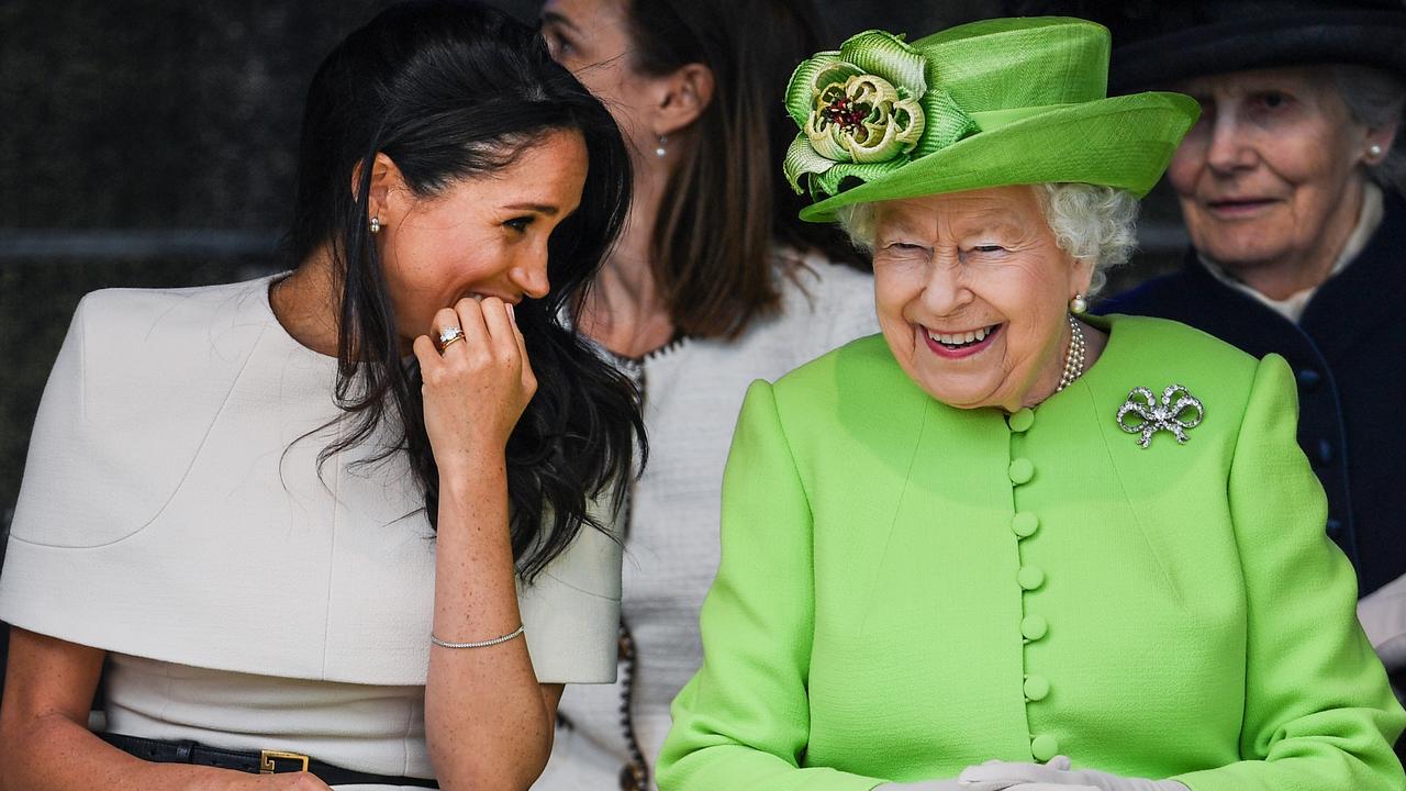 Queen Elizabeth II sits and laughs with Meghan, Duchess of Sussex in 2018 – two years before Megxit. Picture: Jeff J Mitchell/Getty Images