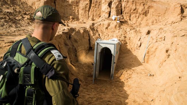 A 2018 picture from the Israeli side of the border with the Gaza Strip shows an Israeli army officer walking near the entrance of a tunnel leading to Gaza. Picture: AFP