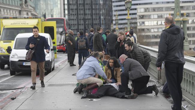 Injured people are assisted after a car mowed down pedestrians on London’s Westminster Bridge. Picture: Reuters