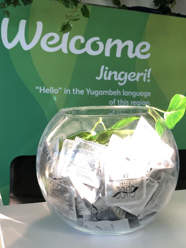 A condom bowl in front of a ‘welcome’ sign at the athletes village. Picture: Greg Stolz