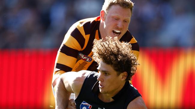 MELBOURNE, AUSTRALIA - AUGUST 11: Charlie Curnow of the Blues is tackled by James Sicily of the Hawks during the 2024 AFL Round 22 match between the Carlton Blues and the Hawthorn Hawks at The Melbourne Cricket Ground on August 11, 2024 in Melbourne, Australia. (Photo by Michael Willson/AFL Photos via Getty Images)