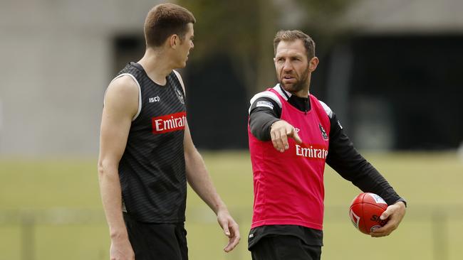 Mason Cox takes direction from former Collingwood player Travis Cloke. Picture: Darrian Traynor/Getty