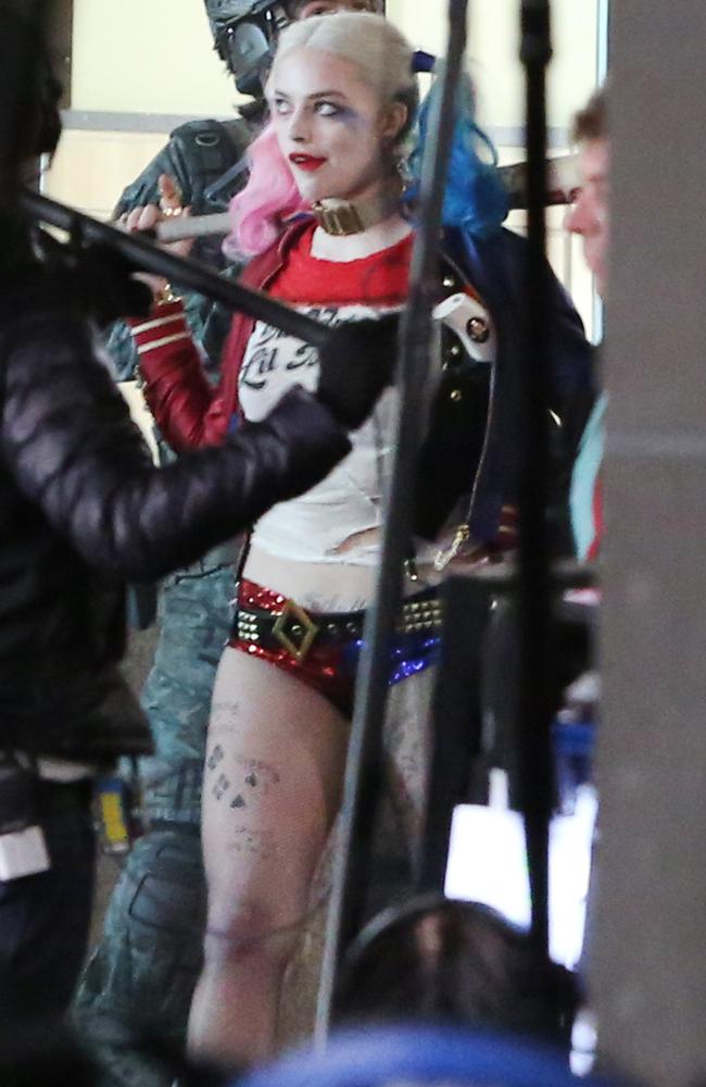 Margot wore sequined hot pants and a dog collar while strutting around in character.