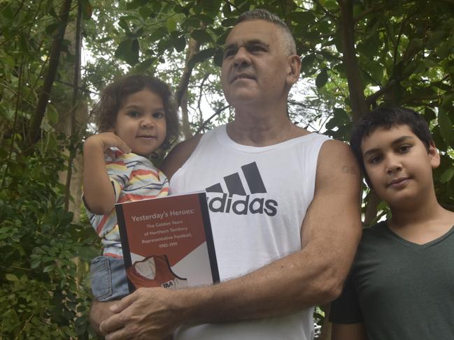 Gregory Bruce, with grandchildren Xavier and Elijah, has written a book about the NT's great rep teams of the 1980s. Picture: Sierra Haigh.