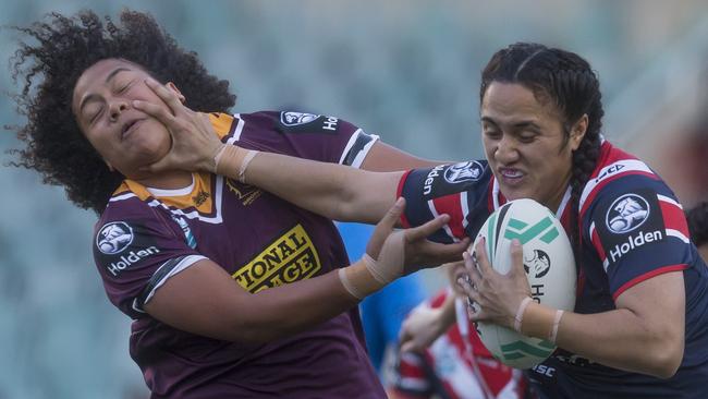 Roosters forward Tazmin Gray fends off a tackle from Teuila Fotu-Moala of the Broncos at Allianz Stadium. Picture: AAP