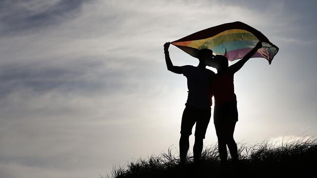 Carly and Christie had a commitment ceremony on the beaches and will get married legally when law changes. Picture: Braden Fastier