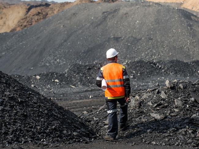 Coal mining in an open pit - Worker is looking on the huge open pit