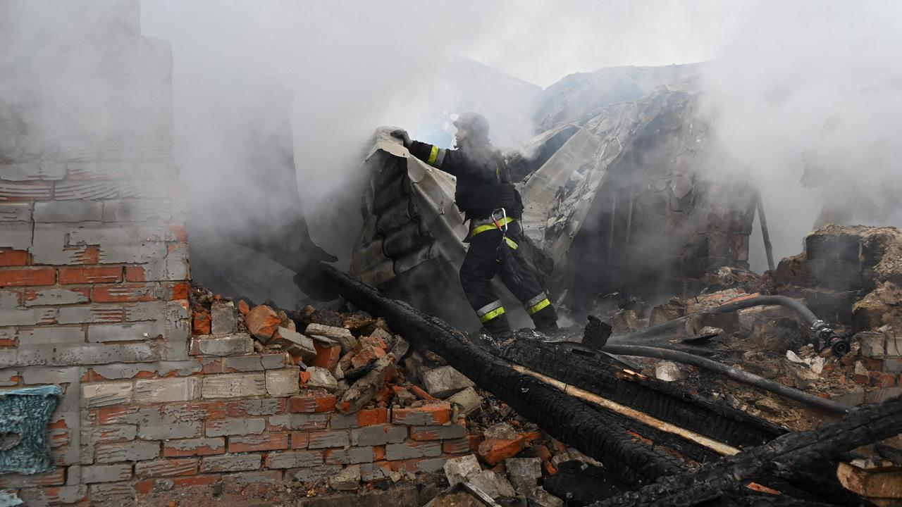A rescuer of the State Emergency Service works to put out a fire in a private house after a drone strike in Kharkiv. Picture: SERGEY BOBOK / AFP