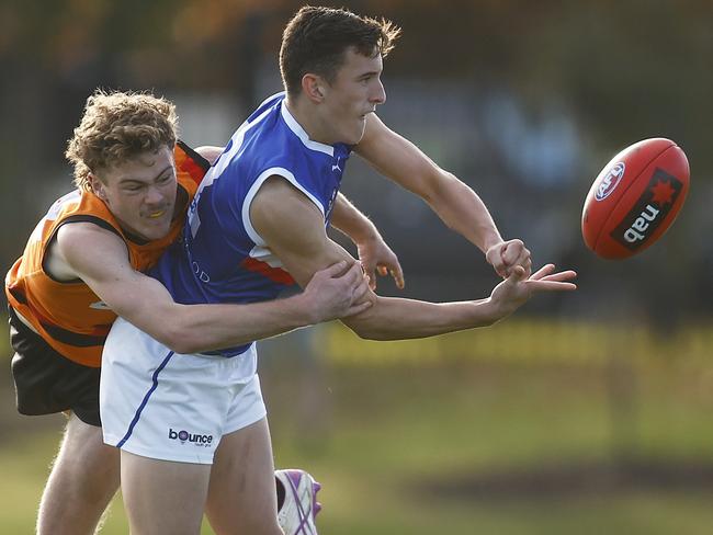 MELBOURNE, AUSTRALIA - JUNE 25: Lachlan Reidy of the Ranges handballs whilst being tackled by Declan Willmore of the Cannons during the NAB League Boys match between Calder Cannons and Eastern Ranges at Highgate Reserve on June 25, 2022 in Melbourne, Australia. (Photo by Daniel Pockett/AFL Photos/Getty Images)