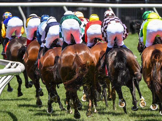 The field passes the winning post for the first time in The Macca's Run at Flemington Racecourse on November 03, 2020 in Flemington, Australia. (Natasha Morello/Racing Photos via Getty Images)