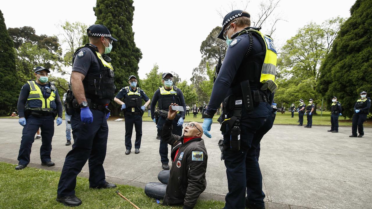 A man is escorted away after shouting insults at police at the Shrine of Remembrance shortly after 2pm. Picture: NCA NewsWire / Daniel Pockett