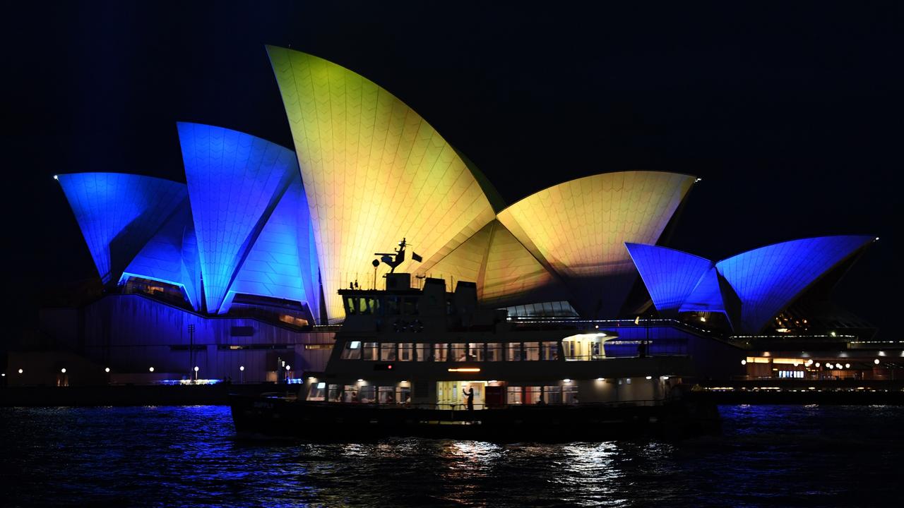 The Opera House sails are lit with the colours of the Ukrainian national flag in Sydney. Picture: James D. Morgan/Getty Images