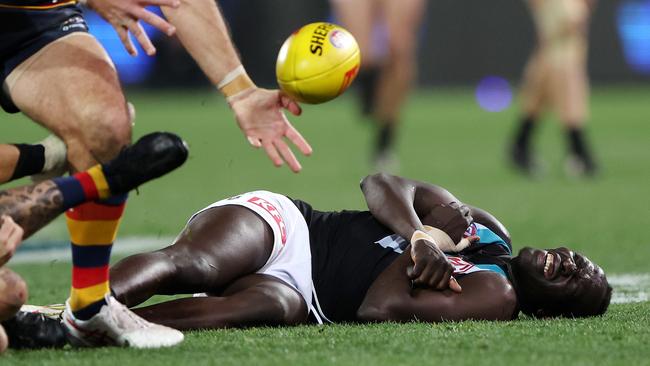 Aliir had to be helped to his feet after the incident. Picture: Sarah Reed/AFL Photos