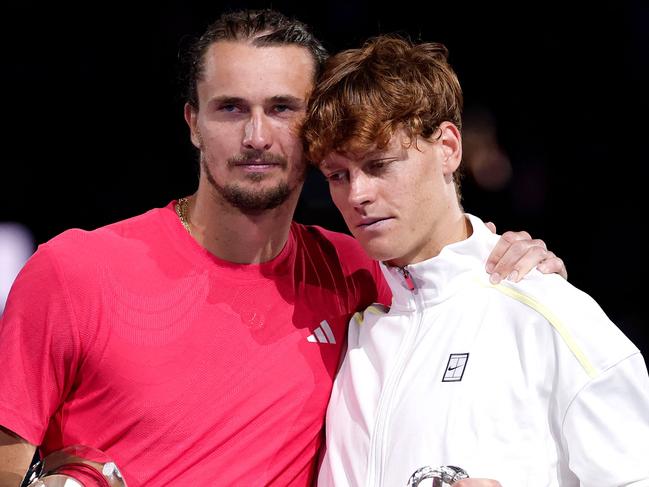 Italy's Jannik Sinner (R) and runners up Germany's Alexander Zverev pose for pictures after their men's singles final match on day fifteen of the Australian Open tennis tournament in Melbourne on January 26, 2025. (Photo by Martin KEEP / AFP) / -- IMAGE RESTRICTED TO EDITORIAL USE - STRICTLY NO COMMERCIAL USE --