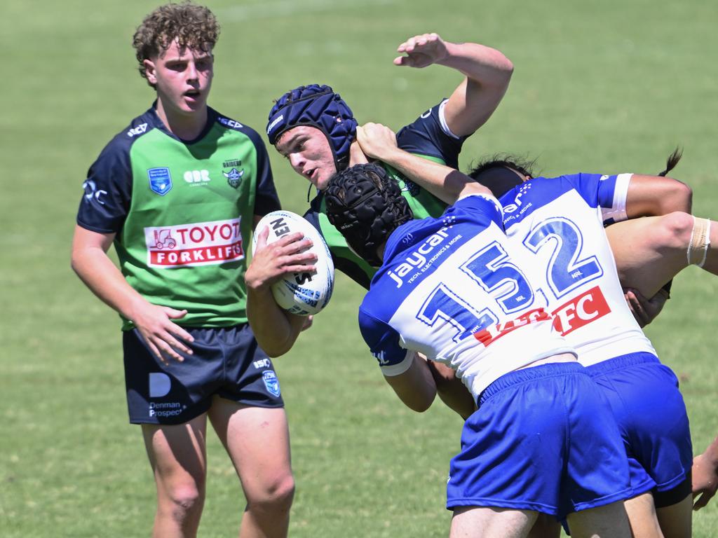 Riley Ivanku is hit by Kanon Phillips (left) and Viliami Mahe. Picture: Martin Ollman