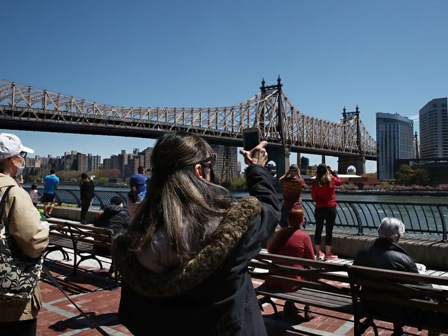 New Yorkers ignored social distancing rules to watch military aircraft fly over the city as a way of thanking essential workers. Picture: Getty Images/AFP