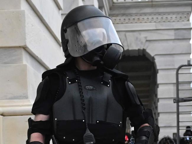 A Trump supporter confronts police and security forces at the US Capitol in Washington, DC, on January 6, 2021. - Demonstrators breeched security and entered the Capitol as Congress debated the a 2020 presidential election Electoral Vote Certification. (Photo by ANDREW CABALLERO-REYNOLDS / AFP)