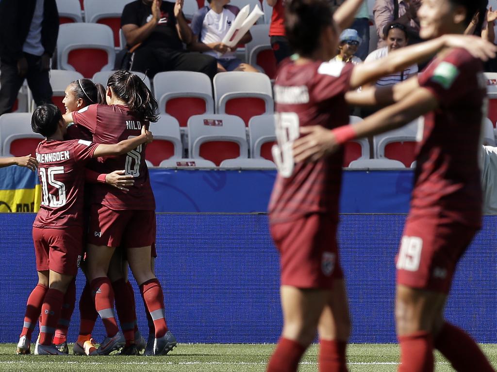 Thailand's players celebrate their side's first goal scored. (AP Photo/Claude Paris)