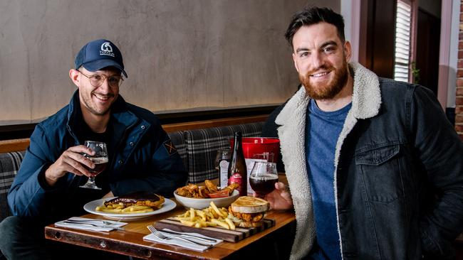 Nick Favaro and Kyle Nash enjoy a much-missed pub meal at the Gilbert Hotel in Adelaide. Picture: Morgan Sette