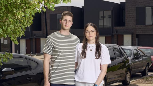 Ben Slade with his partner, Claire Hayward outside their apartment in Woodforde, where streets are congested with cars. Picture: Matt Loxton