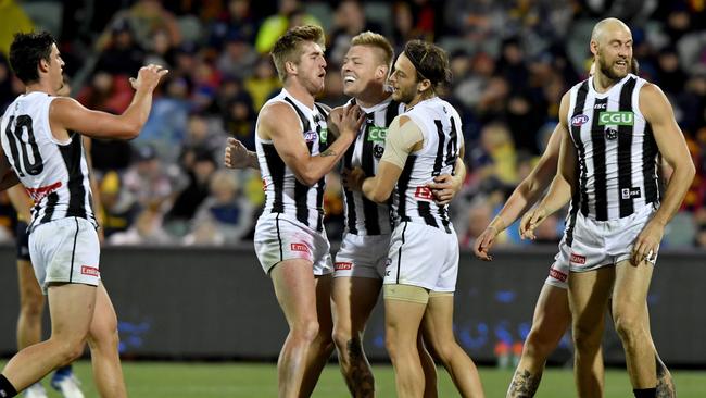 Collingwood players mob Jordan De Goey after a goal in the win over Adelaide. Picture: AAP