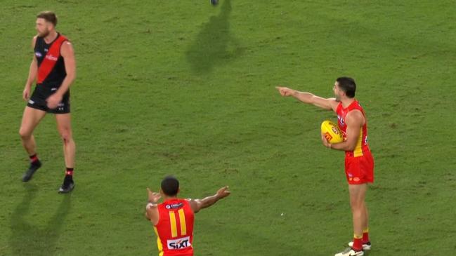 Jayden Laverde (left) was penalised for throwing the ball to the wrong Suns player. Photo: Fox Footy.