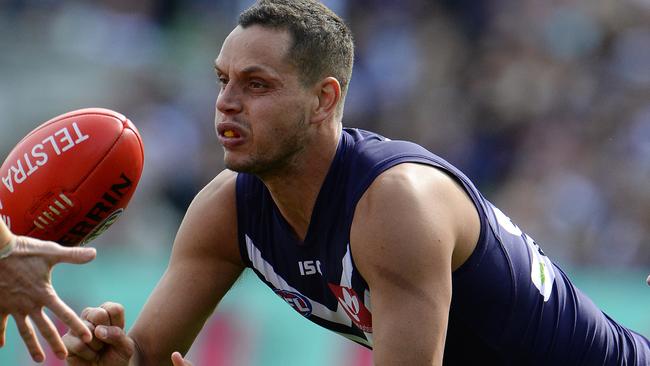 SPORT - AFL, Fremantle Dockers vs Sydney Swans, Subiaco Oval, Perth. Photo by Daniel Wilkins. PICTURED - Fremantle's Michael Johnson gets a handball away under pressure from Sydney's Harry Cunningham