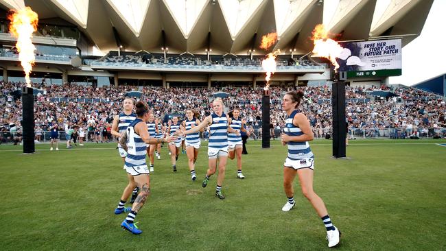 Geelong runs on to the field for its first AFLW game.