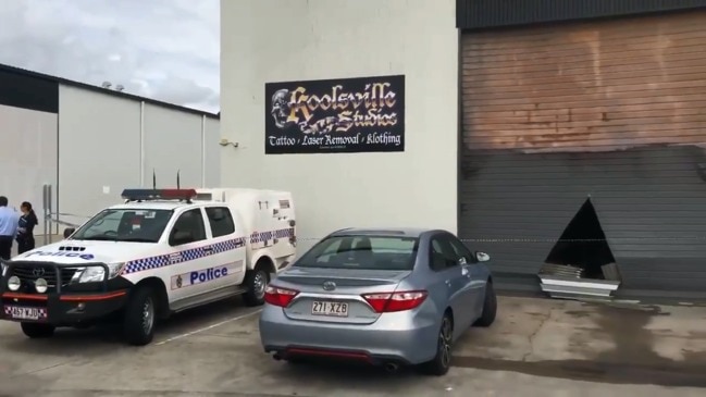 Detectives at the scene after a Brendale tattoo shop was firebombed