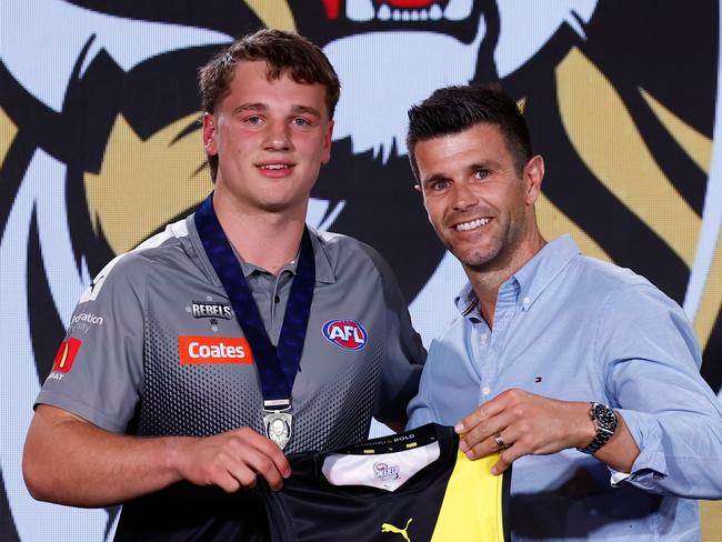 MELBOURNE, AUSTRALIA - NOVEMBER 20: The number one pick, Sam Lalor is presented his jumper by Trent Cotchin during the 2024 Telstra AFL Draft at Marvel Stadium on November 20, 2024 in Melbourne, Australia. (Photo by Michael Willson/AFL Photos via Getty Images)