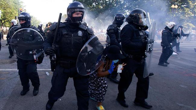 A demonstrator try to pass between a police line wearing riot gear as they push back protesters in Washington. Picture: AFP