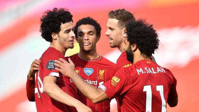 Liverpool's English midfielder Curtis Jones (L) celebrates scoring his team's second goal during the English Premier League football match between Liverpool and Aston Villa at Anfield in Liverpool, north west England on July 5, 2020. (Photo by Paul ELLIS / POOL / AFP) / RESTRICTED TO EDITORIAL USE. No use with unauthorized audio, video, data, fixture lists, club/league logos or 'live' services. Online in-match use limited to 120 images. An additional 40 images may be used in extra time. No video emulation. Social media in-match use limited to 120 images. An additional 40 images may be used in extra time. No use in betting publications, games or single club/league/player publications. /