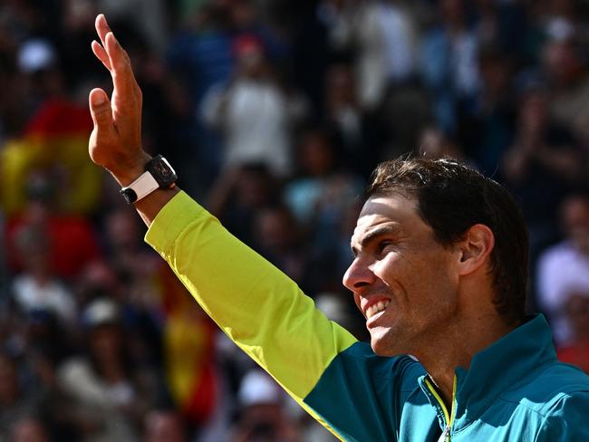 (FILES) Spain's Rafael Nadal waves as he celebrates after victory over Norway's Casper Ruud during their men's singles final match on day fifteen of the Roland-Garros Open tennis tournament. (Photo by Anne-Christine POUJOULAT / AFP)