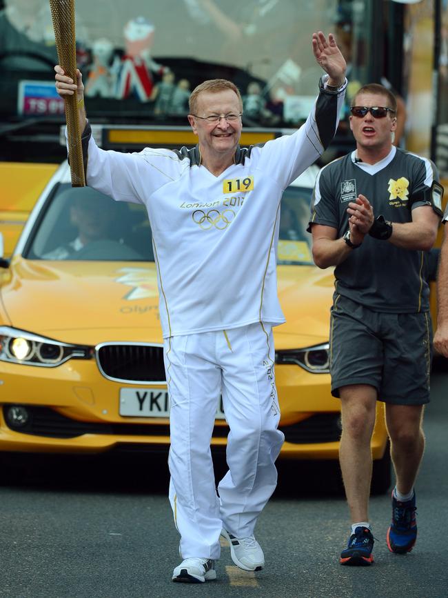 Carrying the Olympic torch ahead of the London Olympics in 2012.