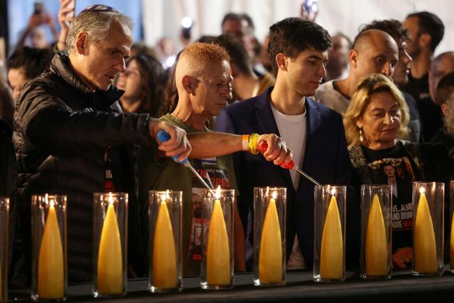 Families and supporters of Israeli hostages still held in Gaza attend a lighting ceremony for a 138-branched menorah representing their number