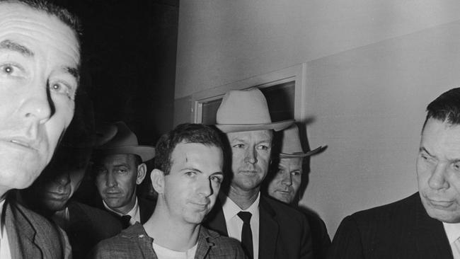 Lee Harvey Oswald (1939 – 1963) (C) is taken into custody by police after allegedly shooting President John F Kennedy. Picture: Getty Images.