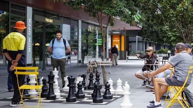 Locals play chess on the giant board in Parramatta Square. Picture: Toby Zerna Media