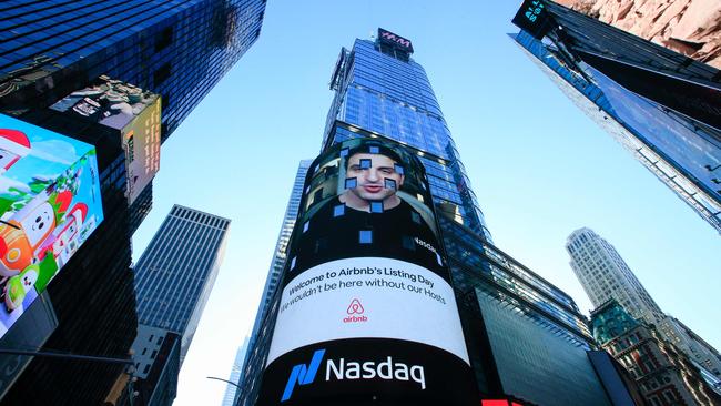 The Airbnb logo is displayed on the Nasdaq digital billboard in Times Square in New York when the homesharing giant Airbnb made its Wall Street debut. Picture: AFP