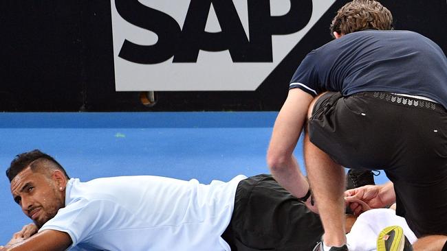 Kyrgios receives medical assistance during a break against Mathew Ebden.