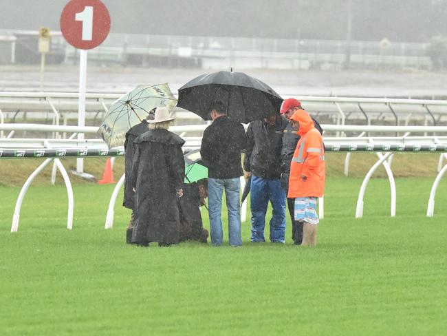 Officials inspect the course proper before being forced to abandon the first meeting at Eagle Farm for almost two years. Picture: Grant Peters, Trackside Photography