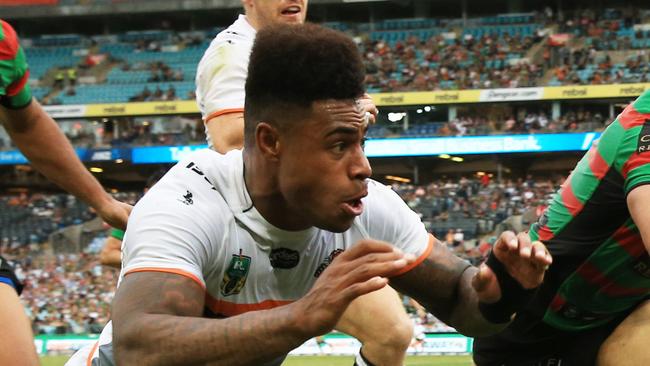 Kevin Naiqama of the Tigers and Greg Inglis of Souths fight for the ball over the Souths dead ball line during the Souths v Wests Tigers NRL round 3 game at ANZ Stadium, Homebush. pic Mark Evans